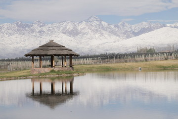 Lake with small house and mountains in the winter