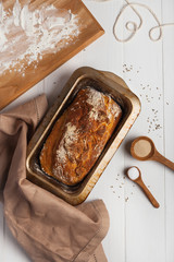 Homemade bread in a baking dish on a white background
