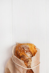 Homemade bread in baking paper on a white background
