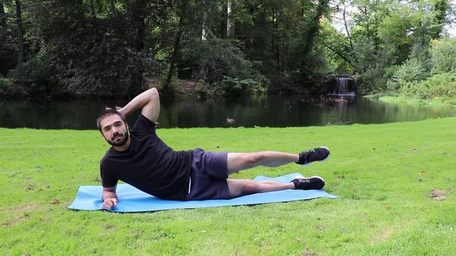 Man doing side jackknife in park 2
