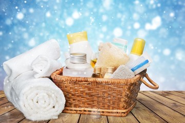 Bath towel and basket with accessories for spa on blur background