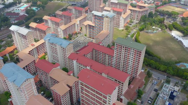 Aerial 4k footage of Public Housing Apartments of Singapore with Singapore skyline In Front Of A Nature Park In Singapore
