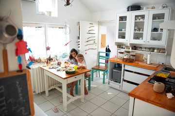 Mother learning her daughter to read	