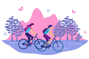 Woman ride bicycles on a background of mountains.