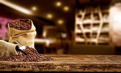 Fresh brown coffee on wooden board with free space for your decoration. Cafe interior and blurred space 