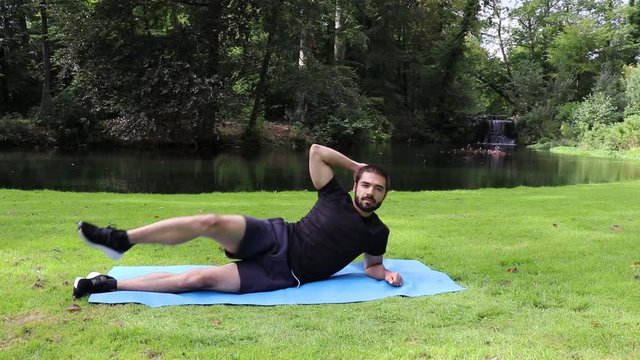 Man doing side jackknife in park