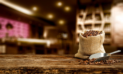 Fresh brown coffee on wooden board with free space for your decoration. Cafe interior and blurred space 