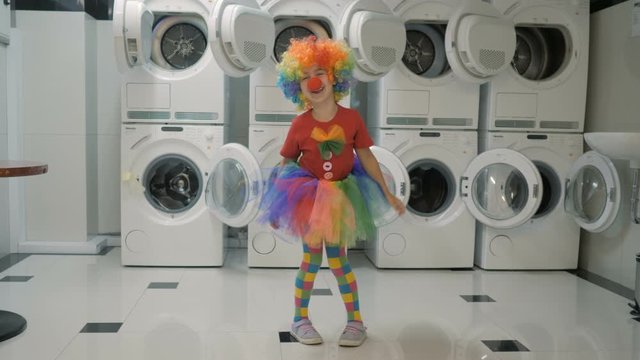 Happy Clown Little Girl Dancing And Have Fun In the Laundry Room. Little Child Clown Enjoying Dance, Having Fun Together, Party. Floss Dance Viral, Flossing. Slow motion.
