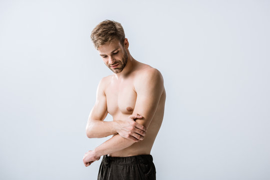 shirtless man with pain in elbow isolated on grey
