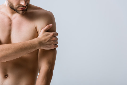 Partial View Of Shirtless Muscular Man With Pain In Arm Isolated On Grey
