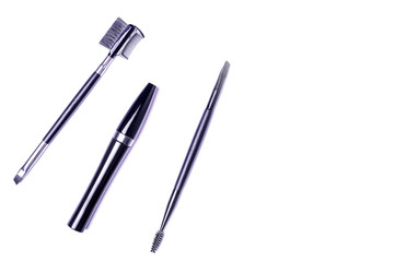 Professional make-up brushes and mascara for eyes isolated on white top view.