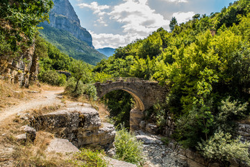 Fototapeta na wymiar Old small arched stone bridge of Lakou or Loli's, between the micro and megalo Papingo villages