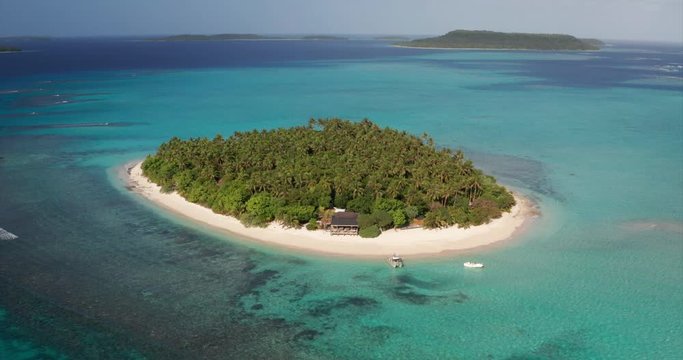 Aerial view of a scenic landscape of desert island with white sand beach and crystal clear sea water bay. 