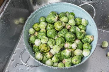 washing raw Brussels sprouts in kitchen sink