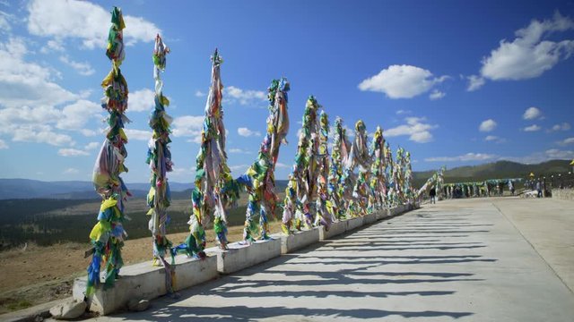 Long Row of colorful Buddhist Prayer Flags Hanging From Tall Polls - Irkutsk, Russia