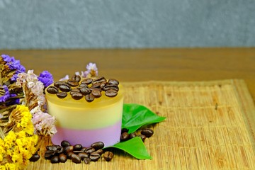 Coffee custard jelly with coffee bean placed on top decorated with green leaves, coffee bean and colorful Statice or Caspia flower on bamboo mat. on bamboo mat.