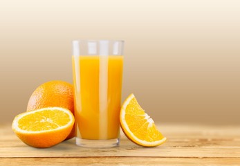 Orange juice and slices of orange on background