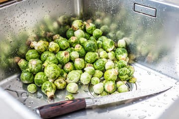 washing raw Brussels sprouts in kitchen sink