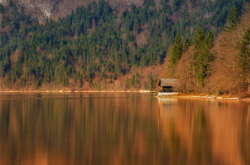 Fototapeta na wymiar Autumn reflections on lake Bohinj, Julian Alps, the largest permanent lake in Slovenia