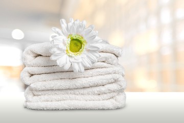 Laundry Basket with colorful towels on background