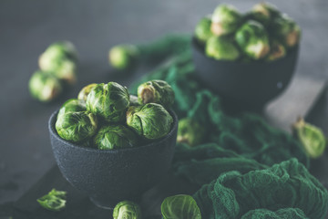 Fresh raw brussels sprouts on a dark wooden table