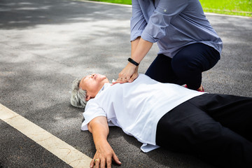 Asian daughter first aid emergency CPR on unconscious senior female caregiver try to resuscitation patient,after accident,heart attack,shock,elderly woman with cardiac arrest while exercise in park