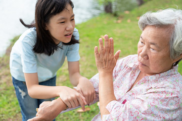 Unhappy asian child girl comfort upset offended senior grandmother,female teenager is stressed to...