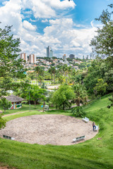 Fototapeta premium Public outdoor activity park surrounded by green trees and toys for physical activities and sports. Children and adults play and have fun in Jundiai, Sao Paulo, Brazil