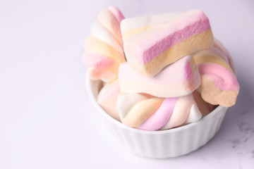 marshmallows in a bowl. Marshmallows on a white background. Pink marshmallows.
