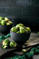 Fresh raw brussels sprouts on a dark wooden table