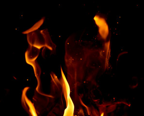 bright orange and yellow flames with sparks, close up