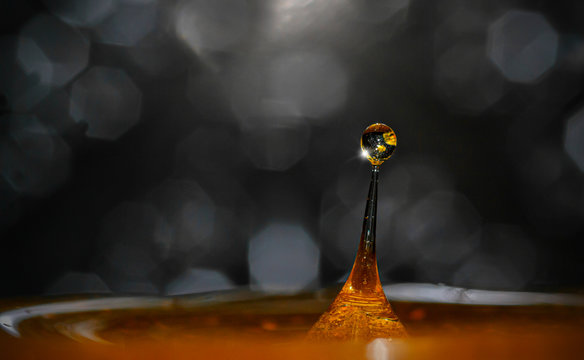 drop & splash of colored water liquid in high speed photography with a beautiful bokeh in the background
