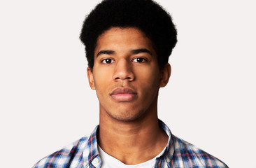 Serious african-american guy portrait on white background