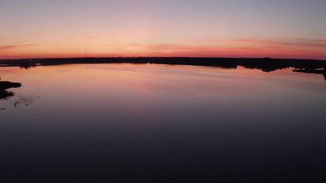 Flight by drone over the bridge of Lake Sirvėna. The wooden pedestrian bridge, the longest in Lithuania, over the artificial lake Sirvėna near Birzai. The bridge is located in Regional Park