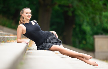 Beautiful sexy woman on the stairs in the park