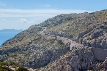 Mallorca panorama view with Mountains and green forest and blue sky and serpentine road 