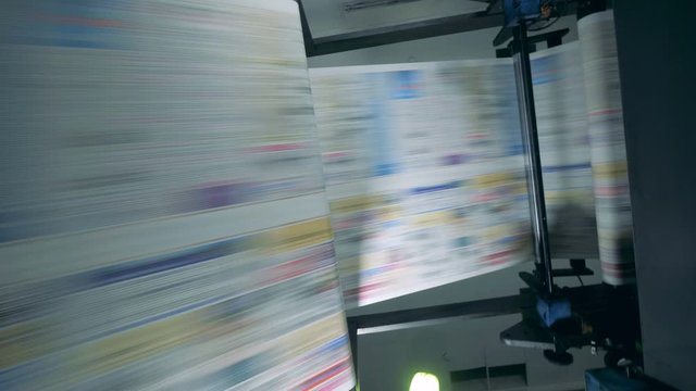 Newspaper moving on a line in a printing office.