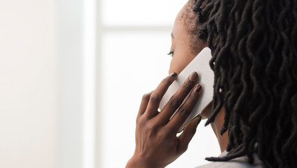 Unrecognizable Businesswoman Talking On Cellphone In Office, Closeup