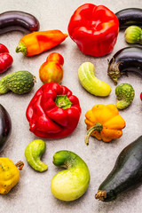 Trendy ugly organic vegetables. Assortment of fresh pepper, eggplant, cucumber, tomato, pumpkin