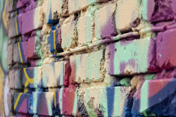 Multi-colored brick wall. Selective focus. Texture