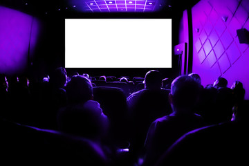Cinema or theater in the auditorium. people watching a movie. Mockup with white blank screen
