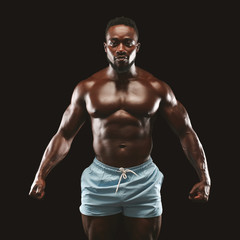 Fototapeta na wymiar Young athletic black man showing naked muscular body