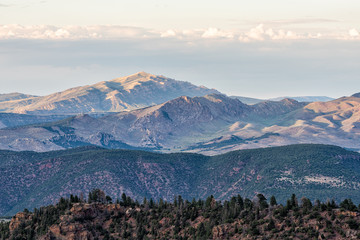 Canyon Rim trail overlook view of mountains near campground in Flaming Gorge Utah National Park at sunset with clouds