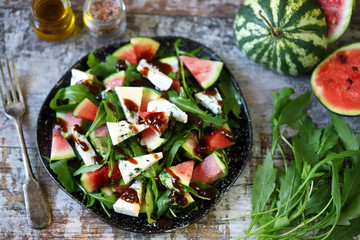 Healthy salad with arugula, blue cheese and mini watermelon. Autumn watermelon salad. Keto friendly. Vegetarian food. Fitness salad. Keto diet. Selective focus. Macro.