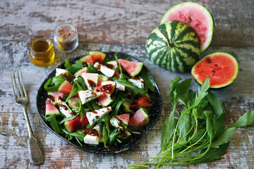 Healthy salad with arugula, blue cheese and mini watermelon. Autumn watermelon salad. Keto friendly. Vegetarian food. Fitness salad. Keto diet. Selective focus. Macro.