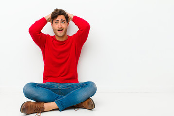 young handsome man looking happy, carefree, friendly and relaxed enjoying life and success, with a...