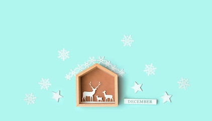 Merry Christmas holiday background. christmas decor. paper reindeers with festive winter decor on blue background. Christmas and New Year minimalism concept. december time. copy space
