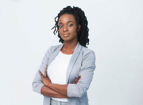 Serious Business Girl Looking At Camera Crossing Hands, Studio Shot