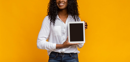 African woman showing blank digital tablet screen