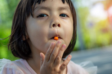 Fototapeta premium Younger children like to eat sweet candies. Sweet candies cause tooth decay.